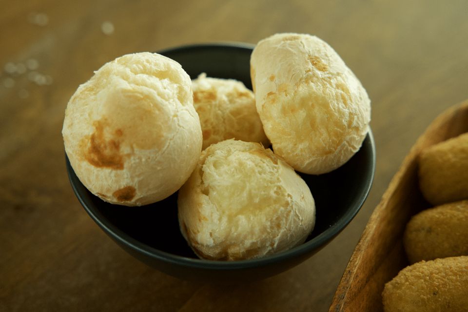 A bowl of freshly baked pão de queijo, Brazilian cheese bread.